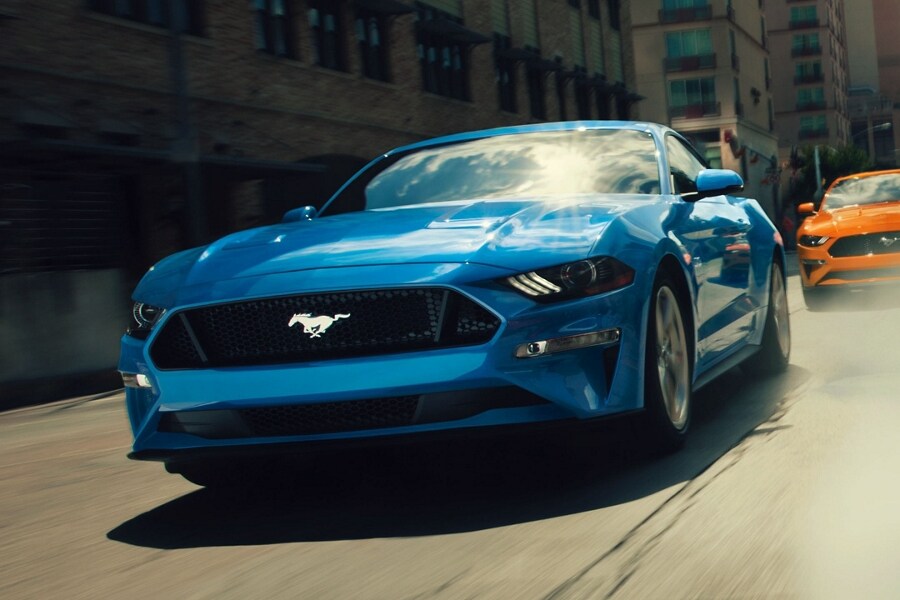 2020 Ford Mustang in Blue followed by a 2020 Ford Mustang in Twister Orange