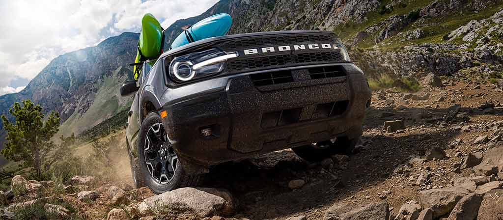2026 Ford Bronco Sport® SUV being driven up a hill on rocky terrain