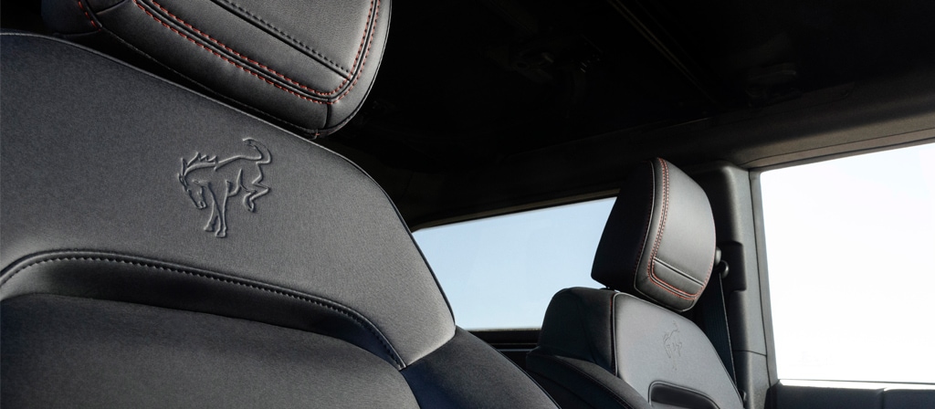 A close-up of the embossed emblem on the front seat upholstery of a 2025 Ford Bronco® Stroppe Edition SUV