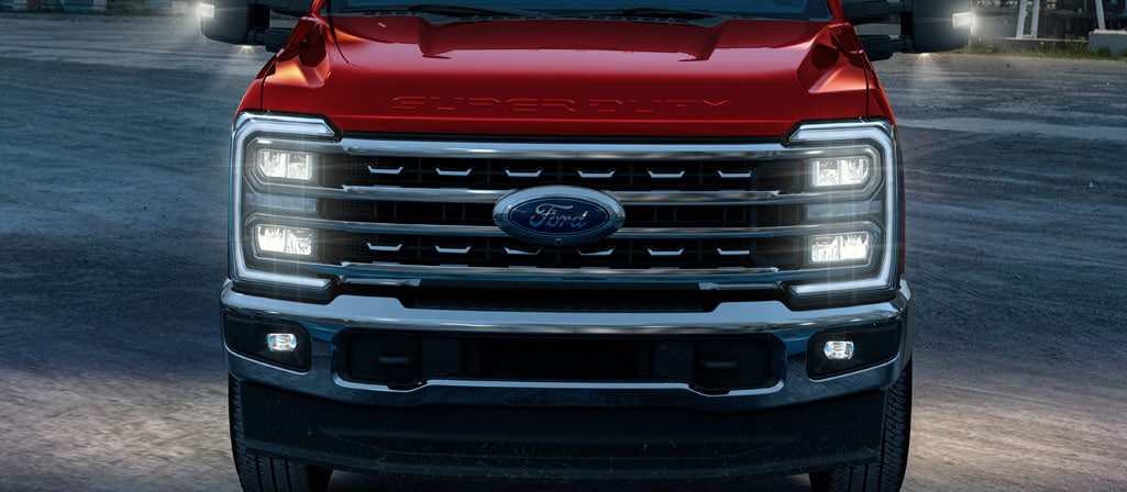 A 2026 Ford Super Duty® Chassis Cab on a job site at night with lights on