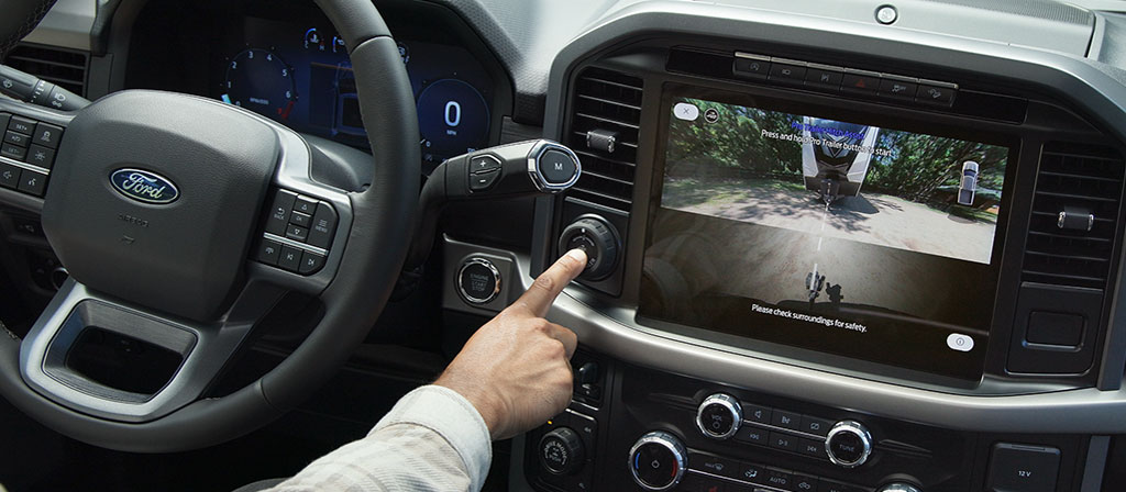 Person activates Pro Trailer Hitch Assist™ using the Pro Trailer knob inside a 2025 Ford F-150® truck