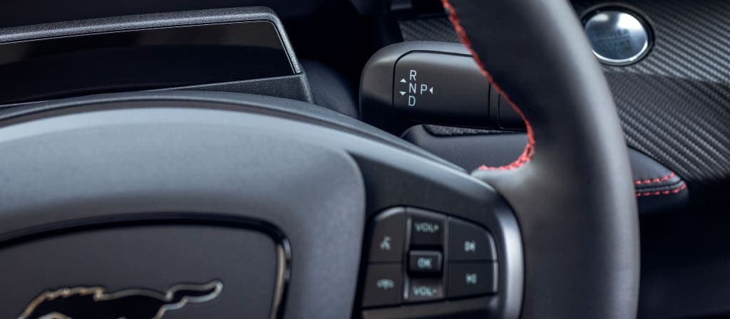 2025 Ford Mustang Mach-E® close-up of steering wheel showing audio controls