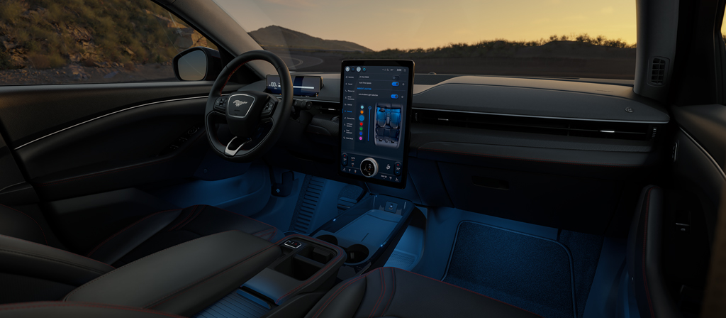 Interior of a 2026 Ford Mustang Mach-E® SUV with a view of the driver's seat, dashboard, and scenic mountain landscape