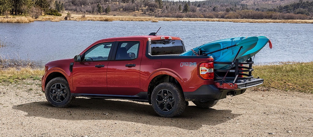 A 2025 Ford Maverick® pickup with available Bed Extender and a kayak in the bed