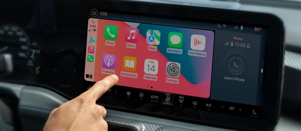 Interior view of a driver using the 13.2" centre touchscreen in a 2025 Ford Mustang®