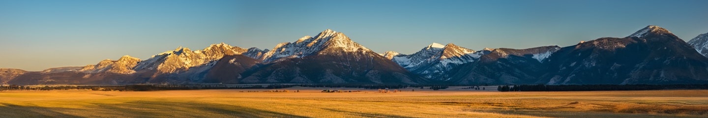 Panoramic image of a mountain range at sunset