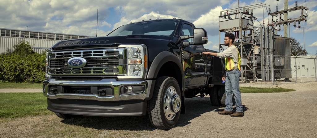 A person opening the driver door of their 2026 Ford Super Duty® F-450® XL model with the Chrome Appearance Package