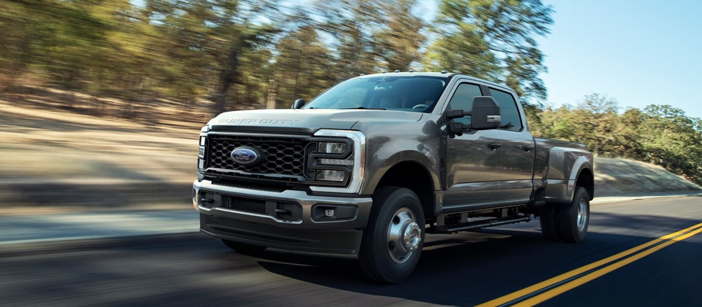 2026 Ford Super Duty® F-250® XL with the STX® Appearance Package in Carbonized Grey driving on a paved road