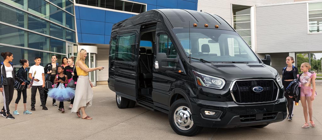 A 2025 Ford Transit® Van parked with a woman and many kids around it