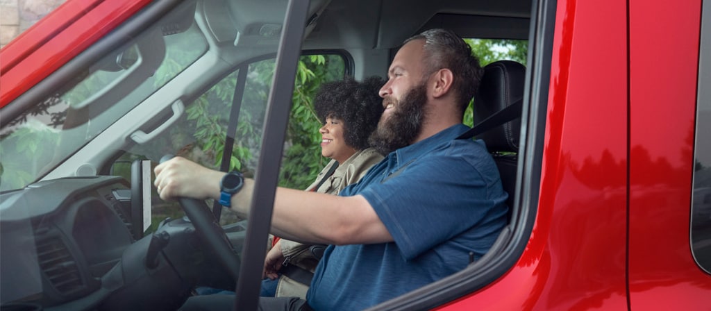 Close-up of two people driving in a 2026 Ford Transit® van