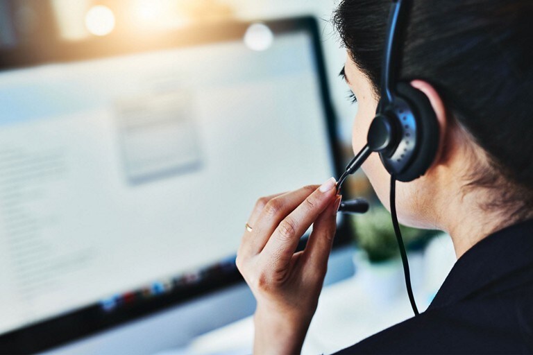 A support employee talking into a headset microphone