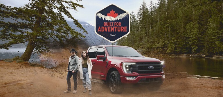 Red 2021 F-150 parked on a river bank. Built For Adventure.