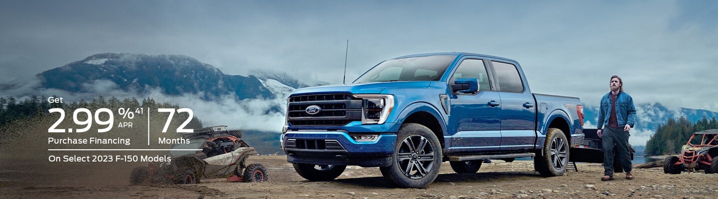 Get 2.99% 41 APR Purchase Financing, 72 Months on Select 2023 F-150 Models. A man stands next to a blue 2023 Ford F-150 with two muddy adventure vehicles nearby. Snowy mountains loom in the background.