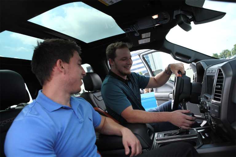 A student driver and instructor in the cabin of an f 1 50