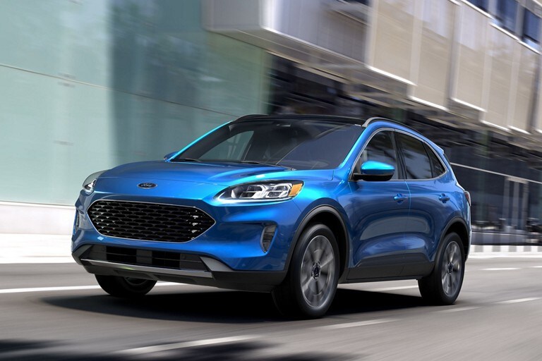 A blue 2021 Ford Escape driving on a city street