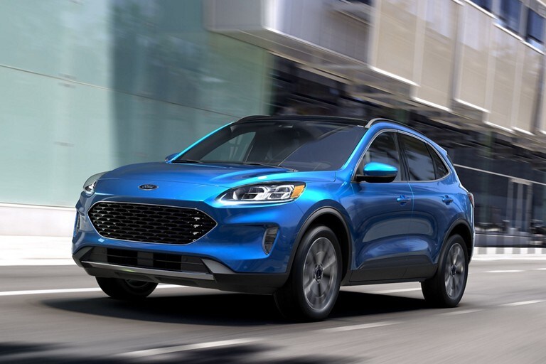  A blue 2021 Ford Escape driving on a city street