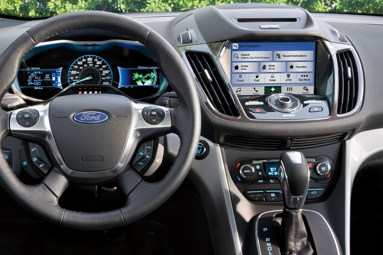 Interior of vehicle showing steering wheel and center dash panel