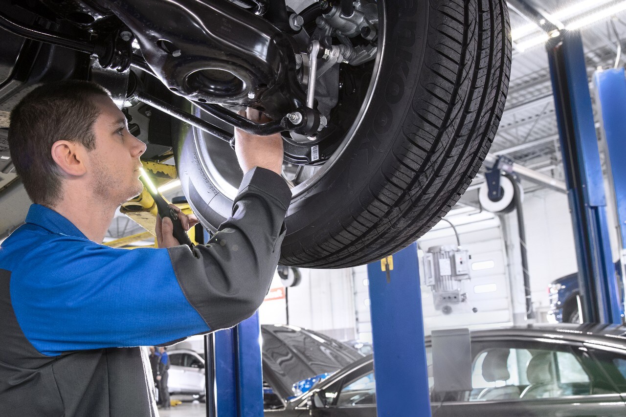 Mechanic inspecting front brake assembly