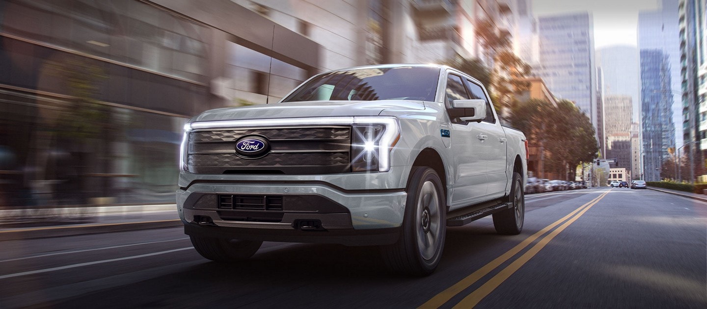F-150 Lightning driving on an urban road.