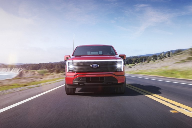 F-150 Lightning driving on a two-lane highway.