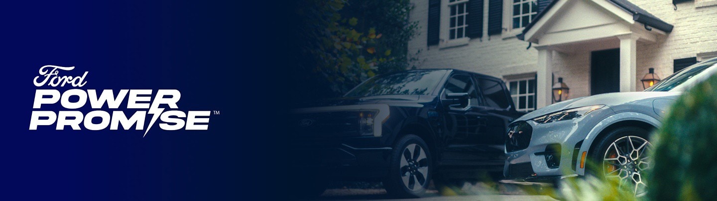 An F-150 Lightning and Mustang Mach-E parked outside of a white brick home with the Ford Power Promise logo overlaid