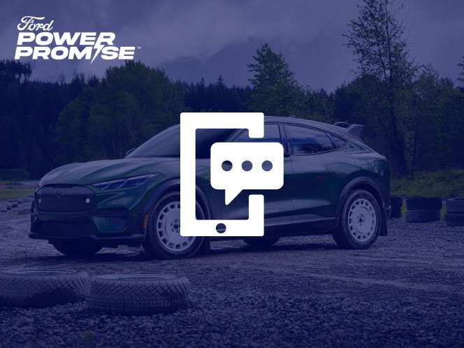 A green Ford Mustang Mach-E sitting on a dirt road with trees in the background with mobile phone and text icon overlaid.
