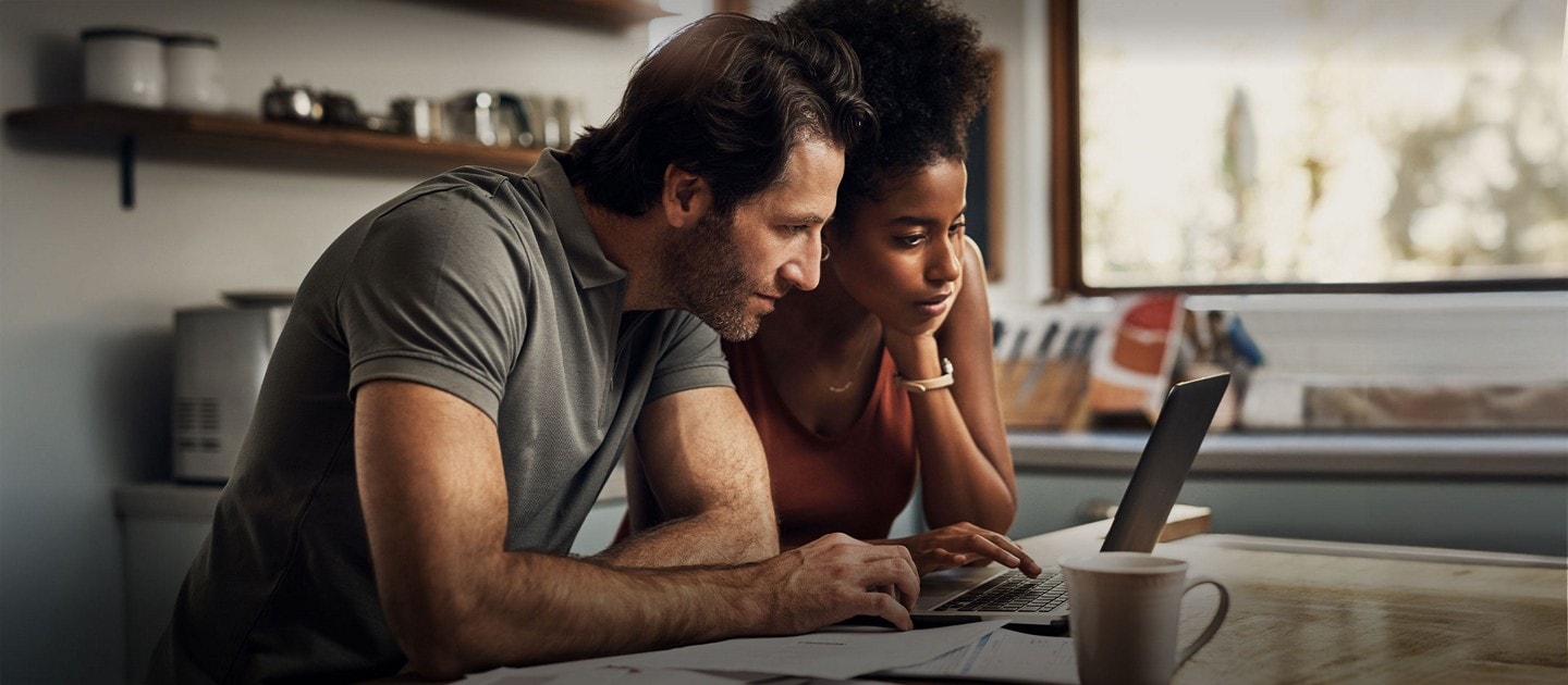 Two people using a laptop.