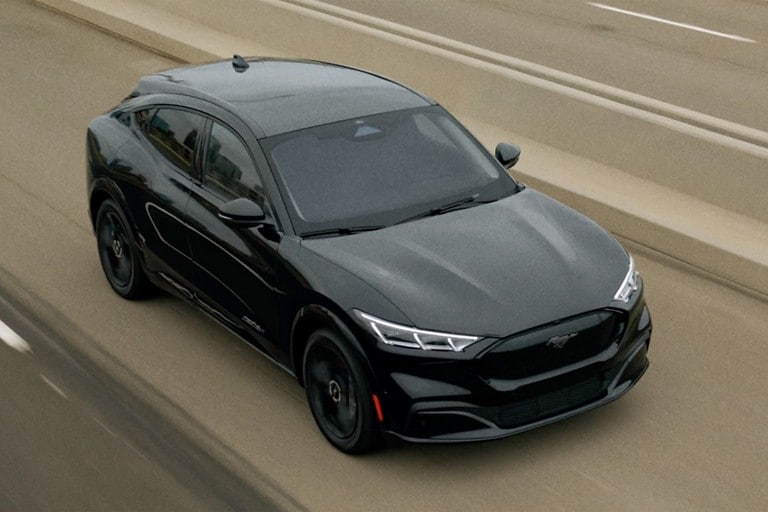 Mustang Mach E driving on a highway.