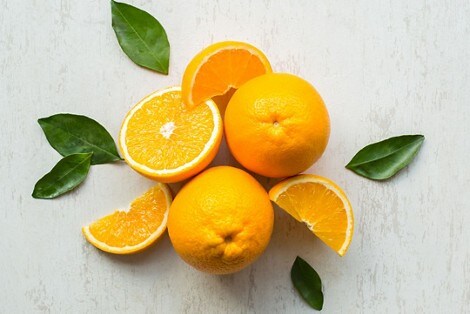A pile of oranges and orange slices