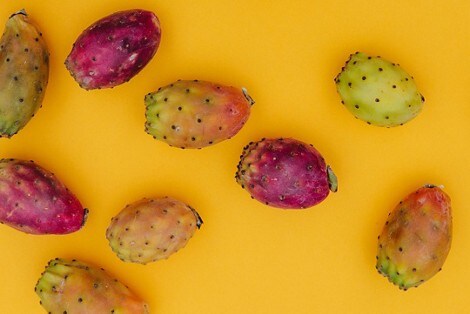 Several prickly pears laying out on a table