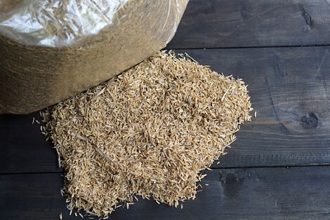 A large bag of rice spilling onto a table