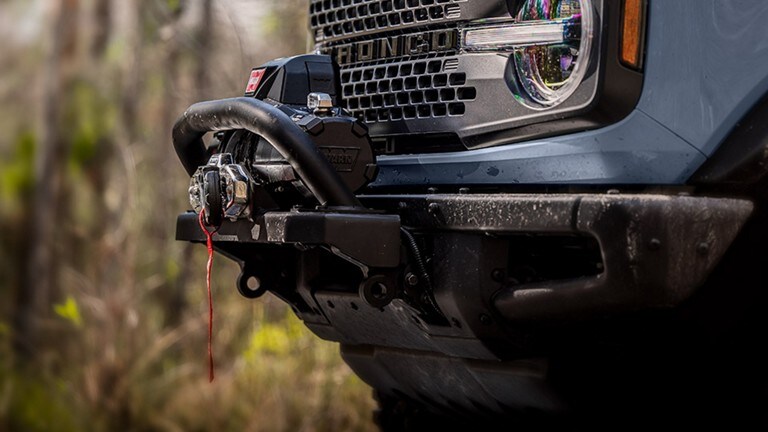 Closeup of a winch on the front of a Ford Bronco
