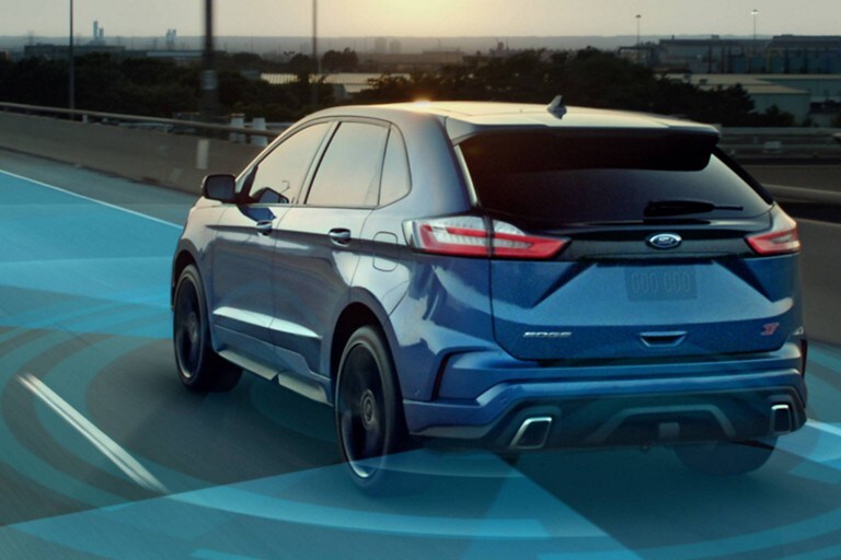 Ford Edge in blue with graphics showing active sensor positions