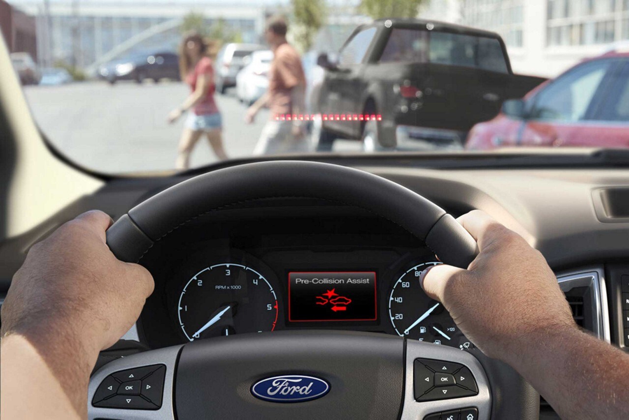 Car senses child crossing the road as it drives toward her