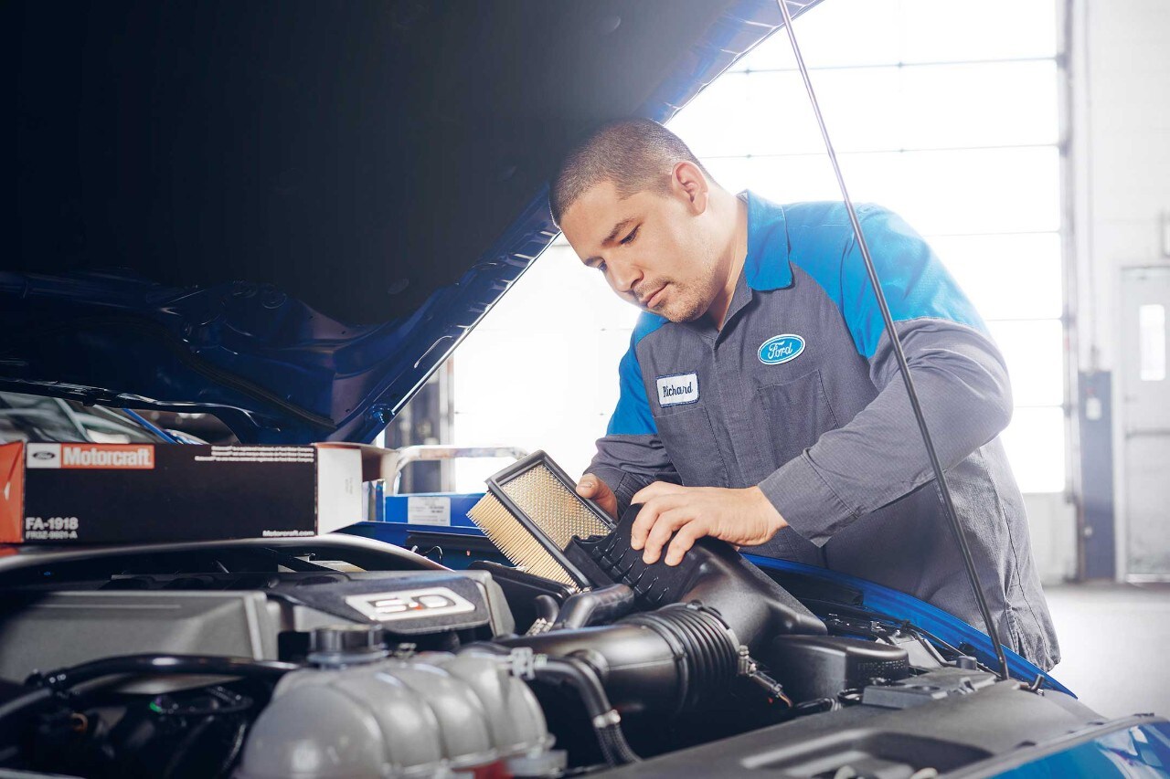 Technician performs an oil change