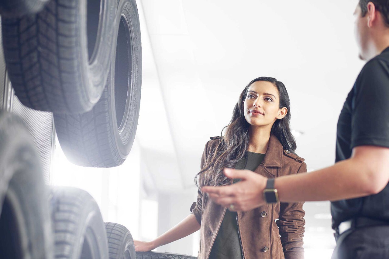 A woman examines new tires
