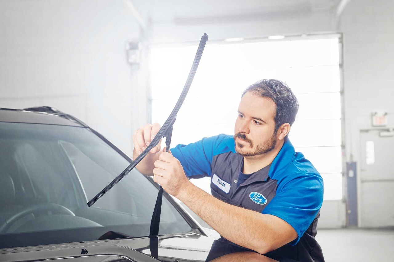 Technician installs wiper blades