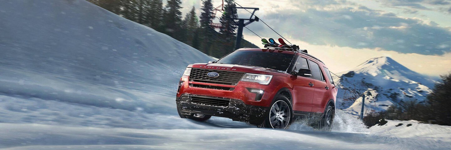 Ford S U V driving up a ski hill