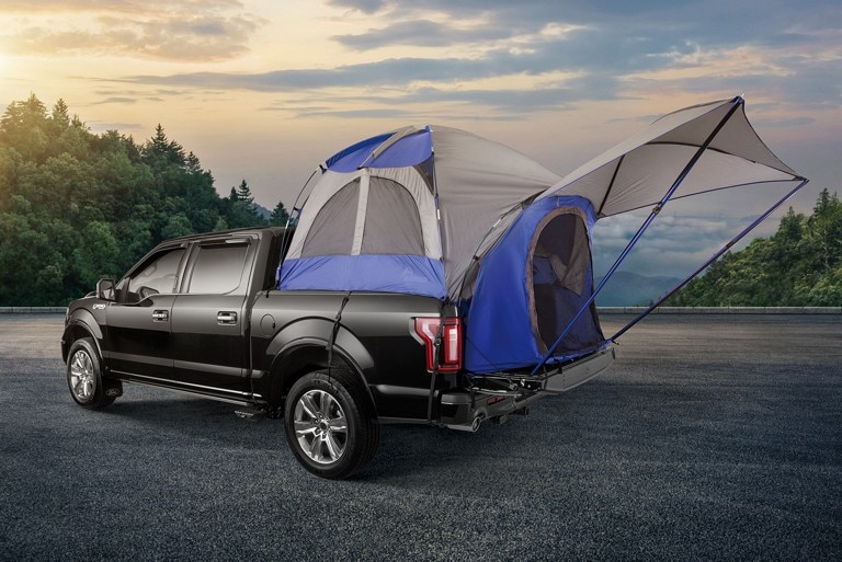 Blue sports tent without cover on the 2021 Ford Ranger truck in Shadow Black parked on a road by the hills