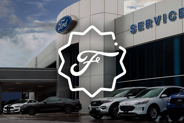 Four Ford vehicles parked in front of a Ford Service Centre