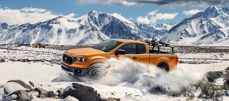 Orange Ford Ranger equipped with a ladder rack accessory