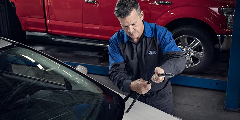 A Ford service technition attaches a wiper blade