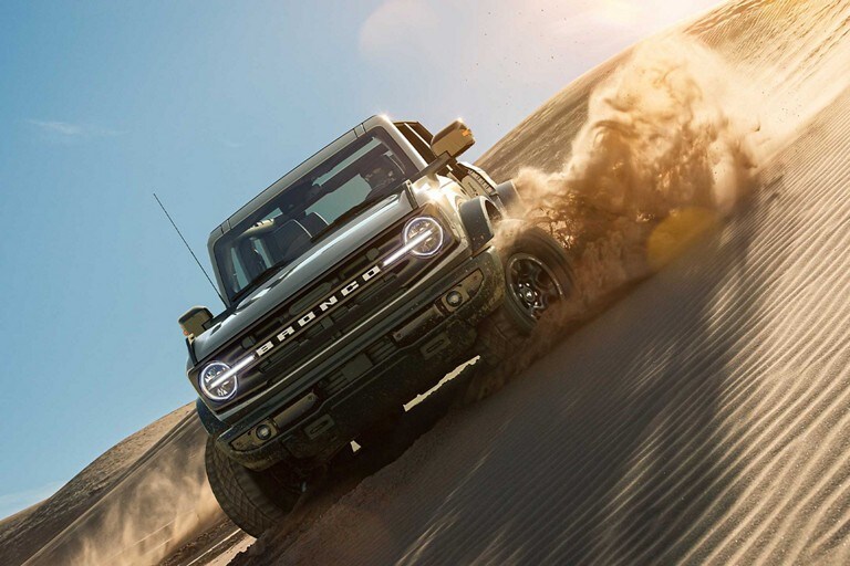 A 2021 Ford Bronco being driven over a rocky terrain