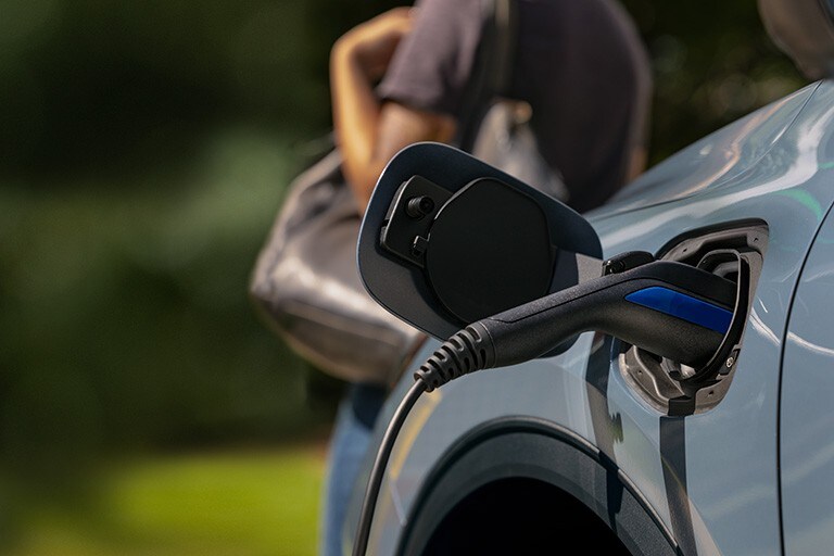 A charger is inserted into a plug-in 2023 Ford Escape