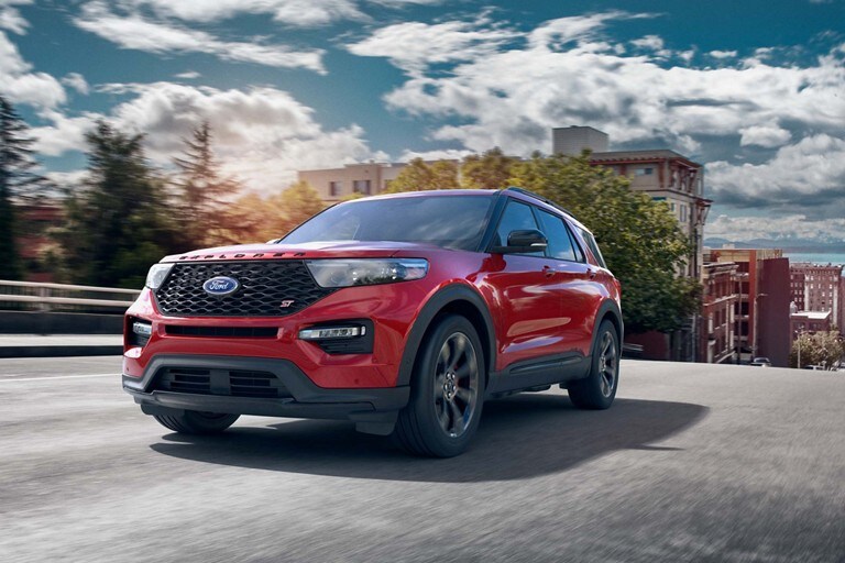 Explorer S T in Lucid Red Metallic driving on a highway.