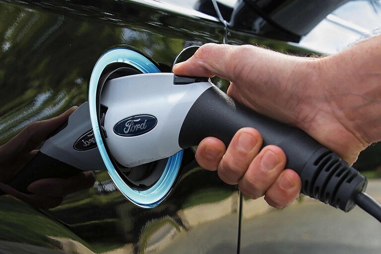 Hand plugging in an electric charger