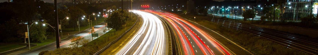 A highway and cars driving at night