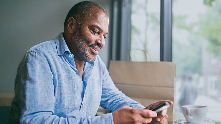 A man uses the FordPass app on a smart phone