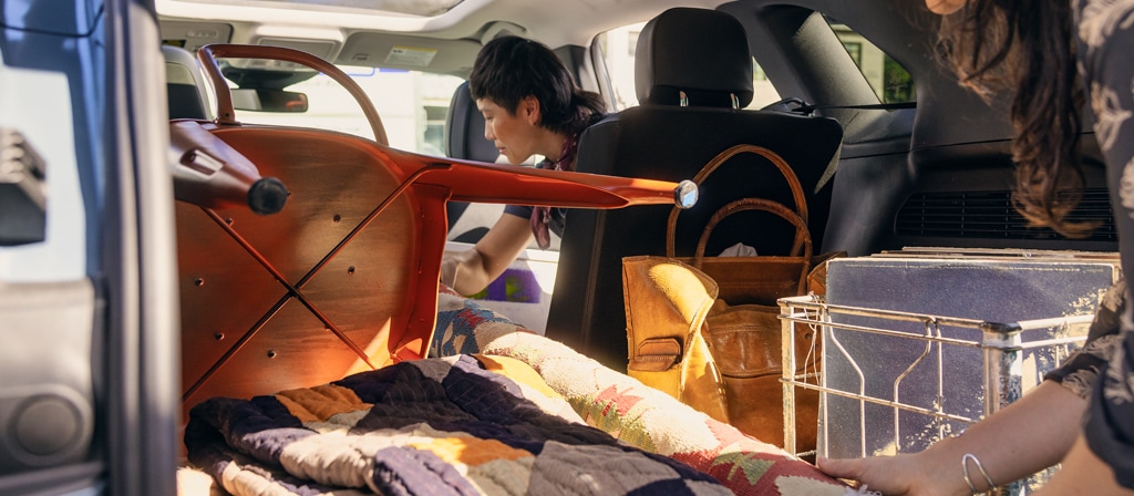 Woman loading items into the cargo area of a 2025 Ford Escape® SUV