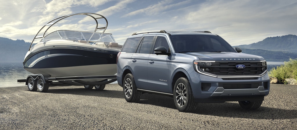 2025 Ford Expedition® model with a driver towing a boat on a trailer